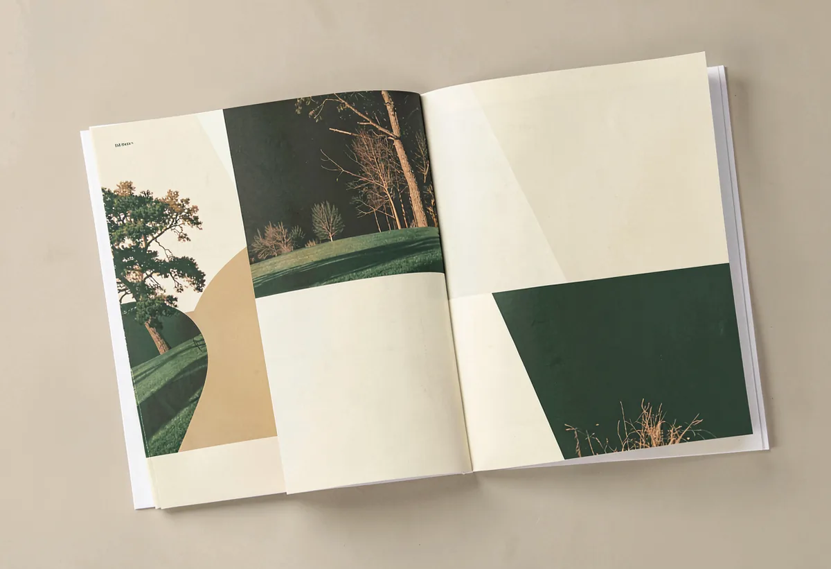 An open printed catalogue with a two-colour cover beside it