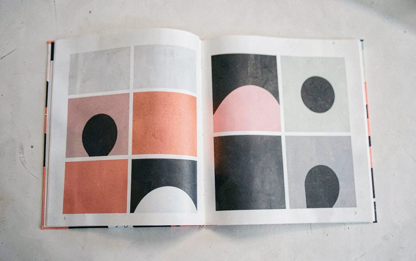 A printed annual report fanned open to show its layout