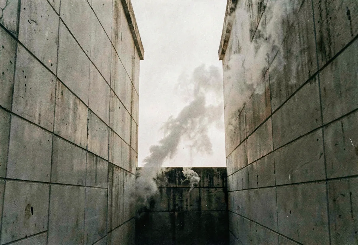 Steam rising from a vent between two towers