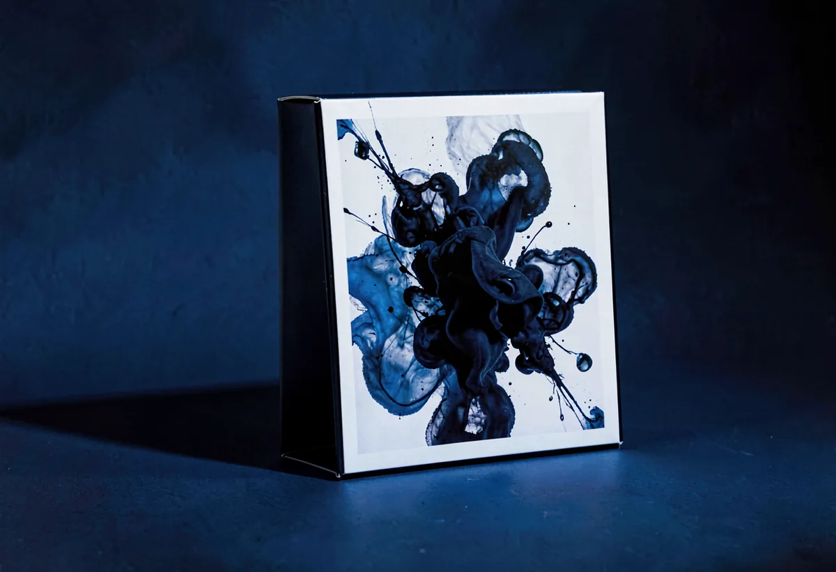 A boxed product photographed on a coloured ground