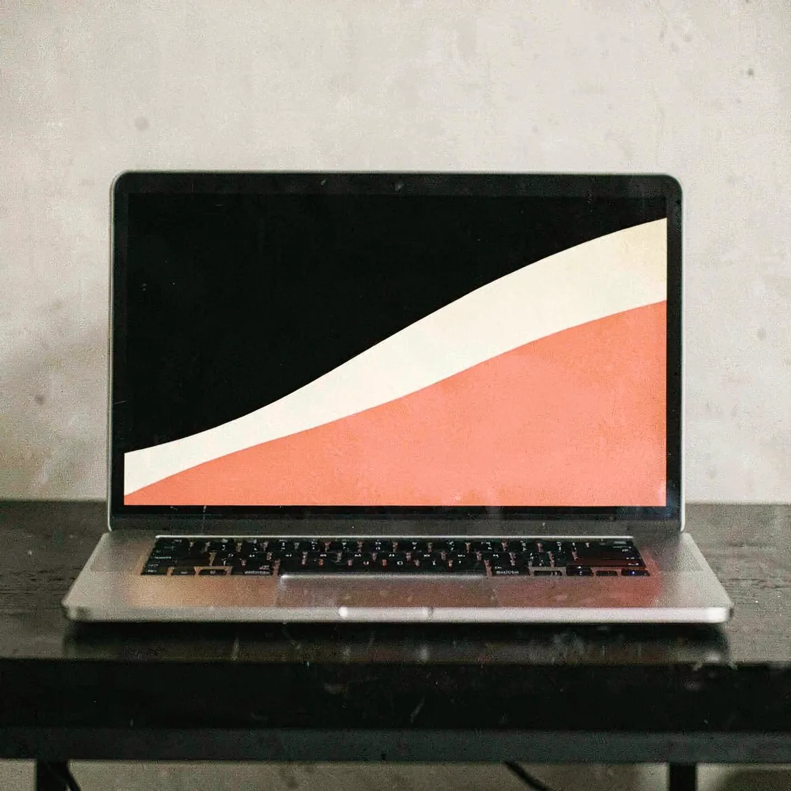 A bold abstract campaign visual filling a laptop screen